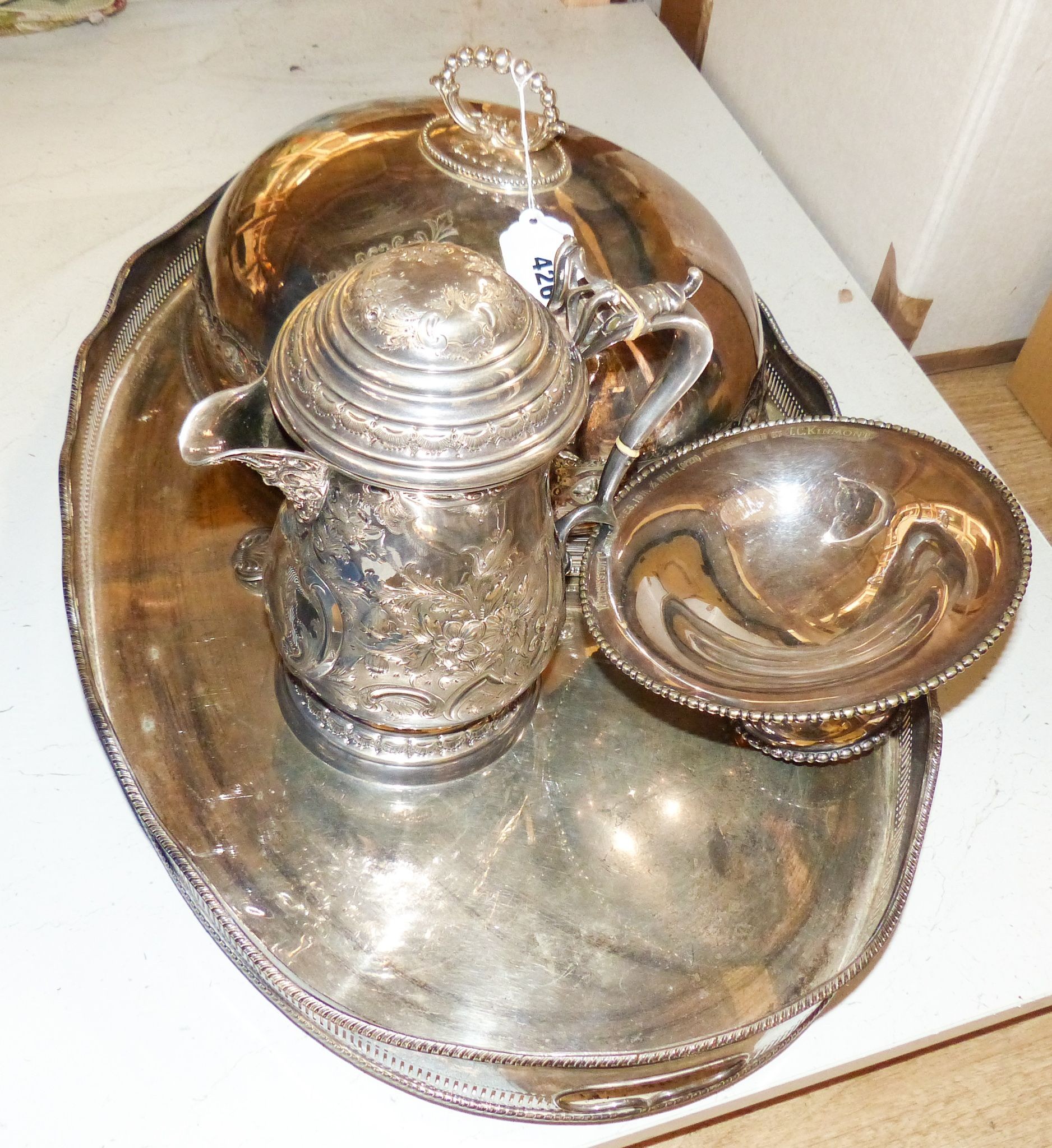 A Victorian embossed silver plated jug, oval tray, meat cover and spoon